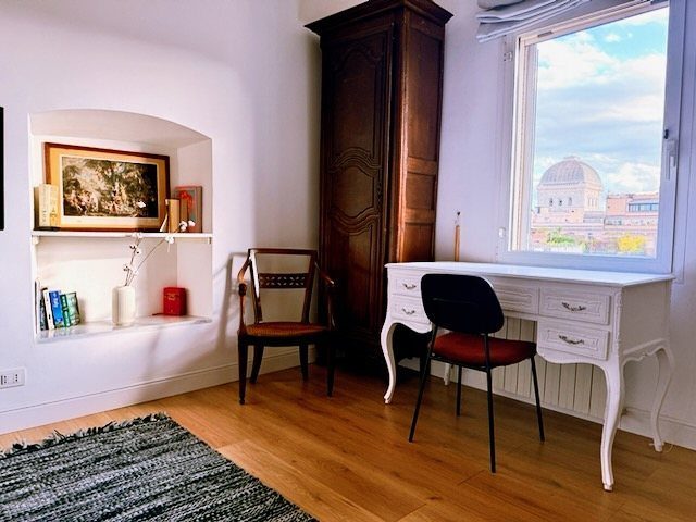The desk by the window, with the dome of the Great Synagogue in view