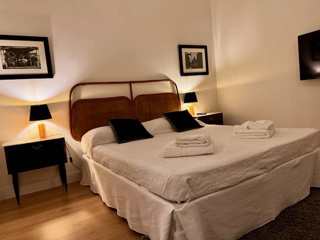 The bedroom with queen-size bed and rattan headboard