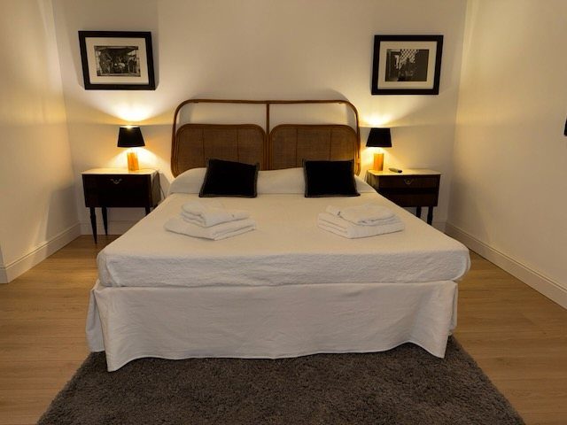 The bedroom, with fresh towels on the bed