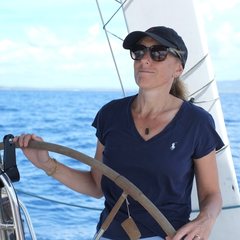 Susanna, your host, at the wheel of a sailboat